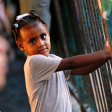 Girl holding a fence